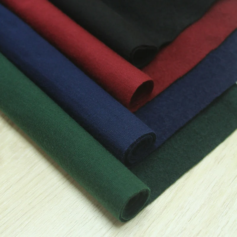 Close view of folded fleece fabric in dark and bright colours (demo photo)
