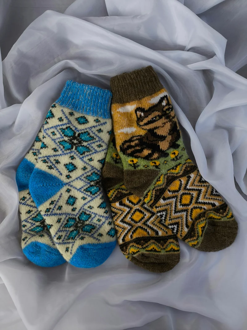 Pair of patterned wool socks on a white cloth (demo photo)