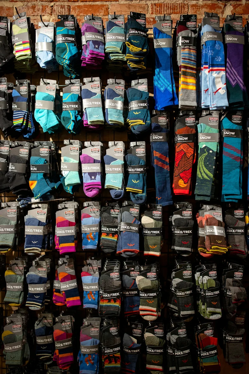 Wall display of colourful performance socks in an outdoor shop (demo photo)